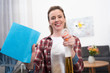 © LIGHTFIELD STUDIOS - selective focus of smiling woman with detergent and rag cleaning home