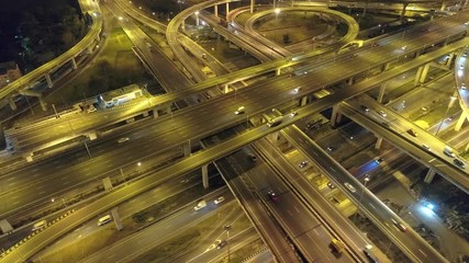 Wall Mural - Video 4K. f traffic on city streets at night. Expressway with car lots in the city in Thailand.  beautiful Street .Aerial view and top view of traffic on freeway.