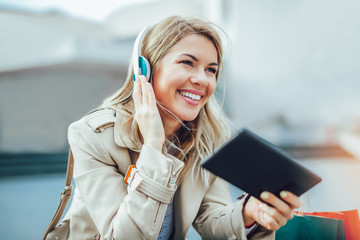 Happy woman watching media content in a digital tablet