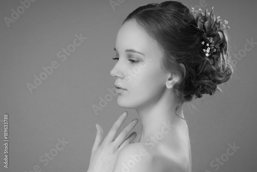 The Girl With The Hair Bun And Light Make Up In Profile On The