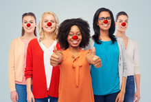 Group Of Women Showing Thumbs Up At Red Nose Day