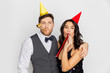 © Syda Productions - happy couple with party blowers having fun