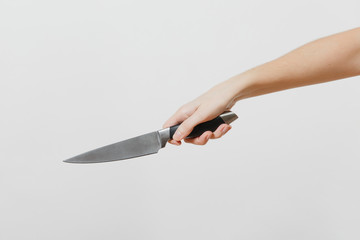 Close up of female hand horizontal holding kitchen knife isolated on white background. Kitchen utensils concept. Copy space for advertisement.