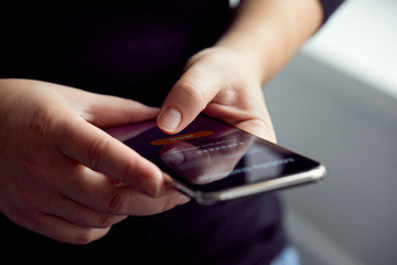 Wall Mural - woman signs up for banking with their mobile phone in the office