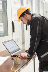 Wall Mural - field service engineer inspect relay protection system with laptop comput
