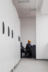 Wall Mural - maintenance engineer inspect relay protection system with laptop computer