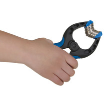 A Hand Holding Blue Clamp With Coins