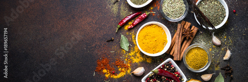Fotografía Set of Various spices on dark stone table.