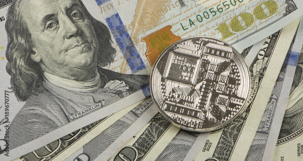 Coin bitcoin against a chaotically arranged 100 dollar bills