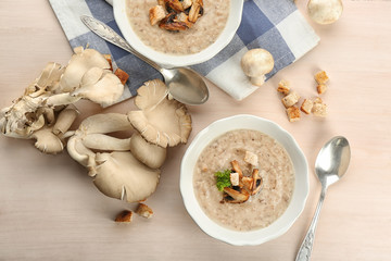 Sticker - Bowl with delicious mushroom soup on wooden table