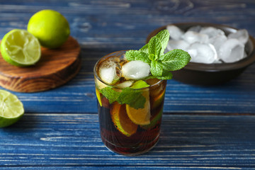 Poster - Glass of Cuba Libre cocktail on wooden table