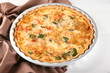 © Africa Studio - Baking dish with tasty broccoli quiche on table