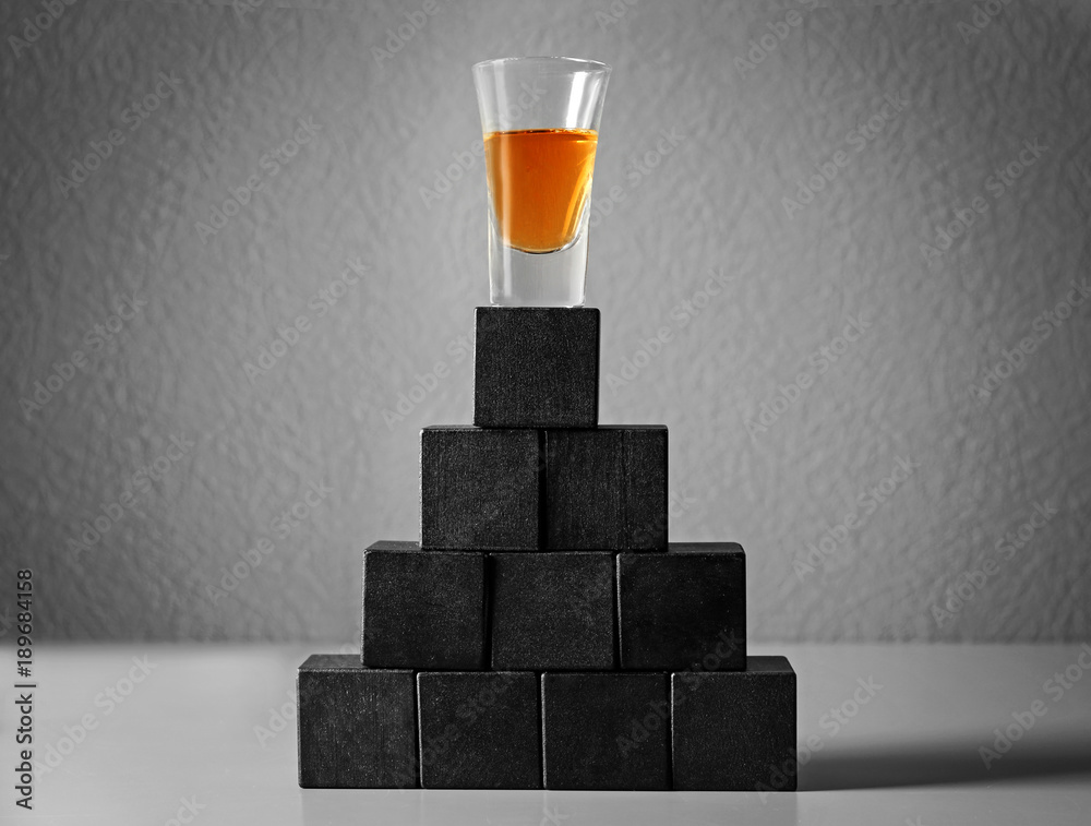 Alcohol drink and cubes with space for text on table