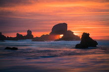 Sunset Behind Arch At Oregon Coast USA