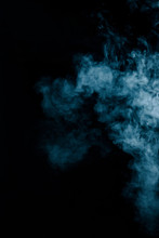 Steam Texture From A Hot Drink On A Black Background. Blue Smoke With Copy Space.