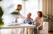 © Halfpoint - Female doctor talking to a senior couple.