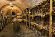 Wine barrels and pecorino cheese (a hard Italian cheeses made from ewe's milk) in a traditional cellar