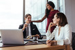 © Jacob Lund - Businessman working with female colleagues in office