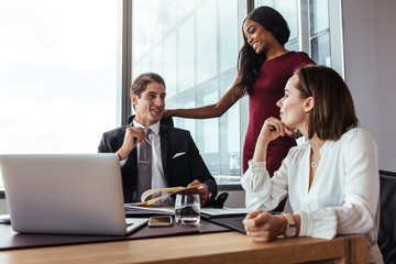 Wall Mural - Businessman working with female colleagues in office