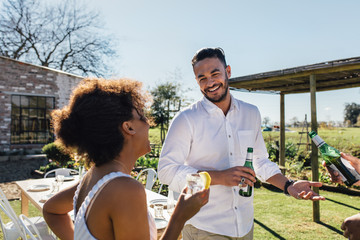 Wall Mural - Man having a party with friends in garden