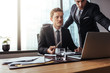 © Jacob Lund - Corporate professionals working together on laptop