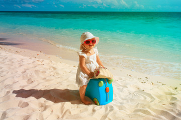 cute little girl travel on summer beach