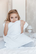 © LIGHTFIELD STUDIOS - adorable kid hugging pillow and looking at camera