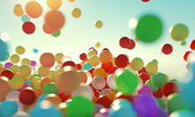 Colorful Bouncing Balls Outdoors Against Blue Sunny Sky