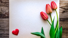 The Picture With Three Red Tulips And Red Heart On Paper