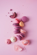 French macarons on pink background.