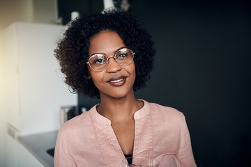 Wall Mural - Confident African businesswoman standing in a modern office