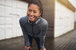 © Flamingo Images - Smiling young Asian woman resting while out for a jog