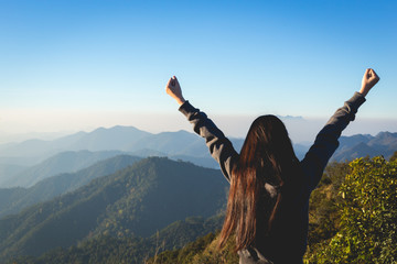 Woman expressing freedom on mountain