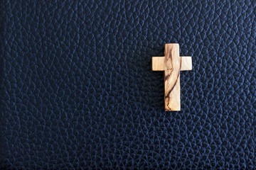 Cross on black leather background