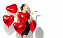 Valentine's Day. Beauty Girl With Red Heart Shaped Air Balloons Having Fun, Isolated On White Background