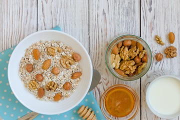 Healthy breakfast of muesli with nuts, honey and milk