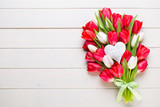 Fototapeta Tulipany - Springt time. Red tulip bouquet on the white wooden background.