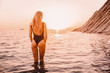 © artifirsov - Blonde woman in swimwear bikini with sunset colors.