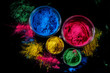 Indian Holi festival colours in four bowls on dark background.
