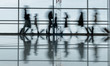 © Yakobchuk Olena - Travel concept. Blurred terminal lounge with walking tourists. They are carrying suitcases. Full length