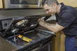 © spatesphoto - Electrician Checking a Stovetop Range