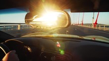 Cabriolet Is Driving Along Russian Bridge (connects The Mainland Part Of Vladivostok With Russian Island), Middle Aged Driver's Portrait In Sunglasses. Sunrise