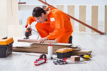 Wall Mural - Contractor working on laminate wooden floor