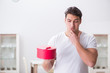© Elnur - Young man with gift bag at home preparing suprise for wife