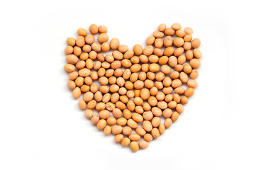 Soybeans, or soya beans, in a heart shape, isolated on a white background