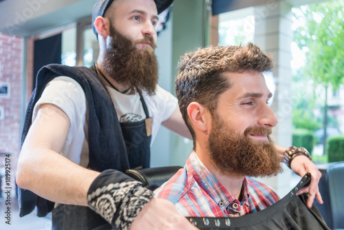 Side View Of A Handsome Young Bearded Man Smiling Before