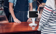 © weedezign - customer self service order drink menu with tablet screen at cafe counter bar,seller coffee shop accept payment by mobile.digital lifestyle concept.Blank space for display of design.clipping path.
