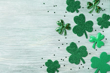 Saint Patricks Day Background With Green Shamrock On White Rustic Board Top View.