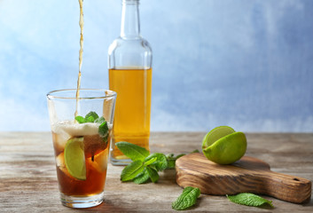 Poster - Pouring cola into glass with Cuba Libre cocktail on table