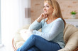 © Africa Studio - Happy mature woman relaxing in armchair at home